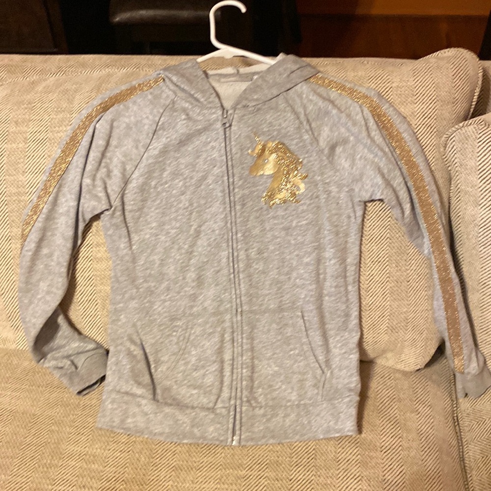 Gray sweater with gold glitter lines on sleeves and gold unicorn on left